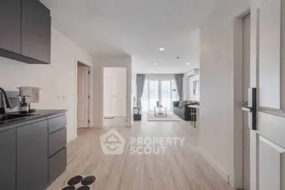Spacious modern apartment with open layout and stylish decor, featuring a bright living area and sleek kitchen.