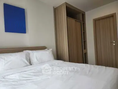 Modern bedroom with cozy bed and built-in wardrobe