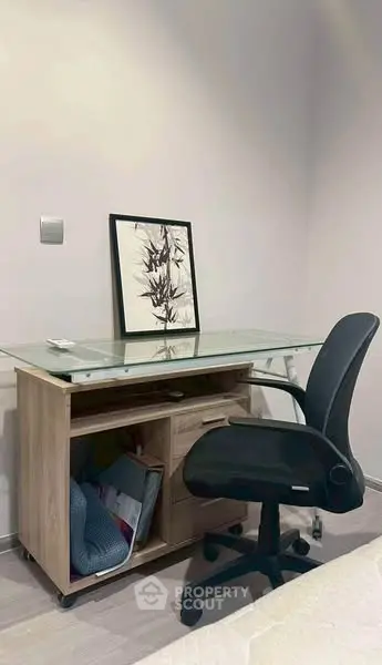 Modern study area with sleek desk and ergonomic chair in a cozy room.