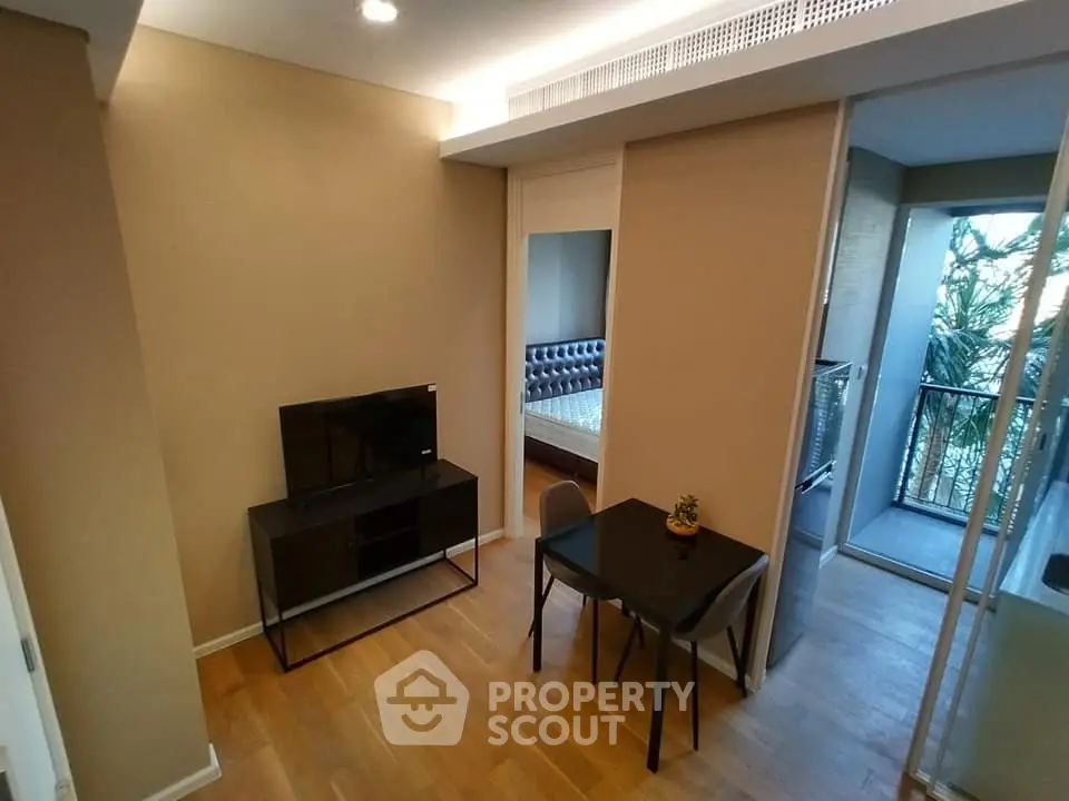 Modern apartment interior with living room, bedroom, and balcony view.