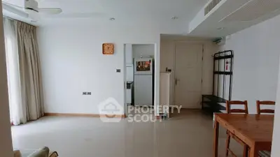 Spacious living room with dining area and kitchen access in modern apartment
