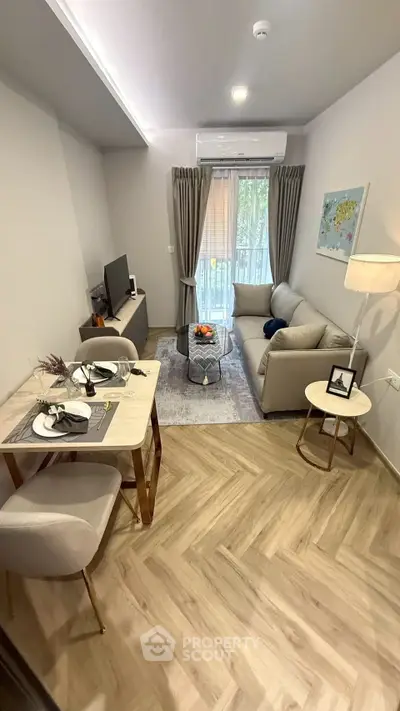 Modern living room with cozy seating and stylish decor, featuring a small dining area and natural light.