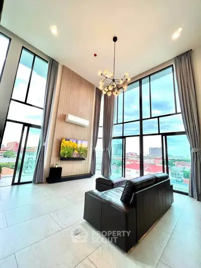Luxurious high-ceiling living room with panoramic city views and modern decor.