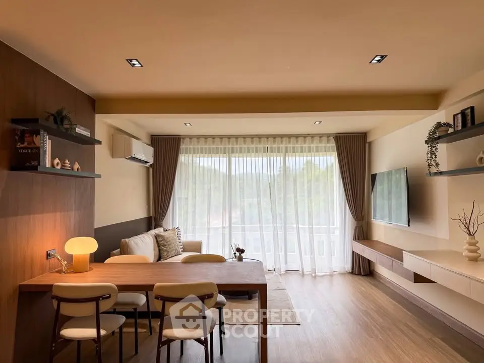 Modern living room with large window and stylish furniture