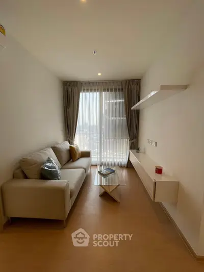 Cozy living room with modern sofa and natural light from large window