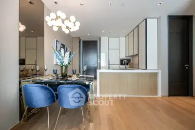 Modern dining area with elegant blue chairs and sleek kitchen design
