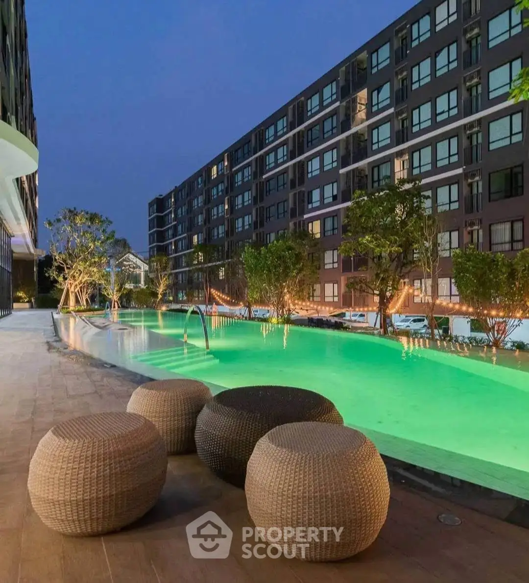 Luxurious apartment complex with stunning poolside view and modern architecture.