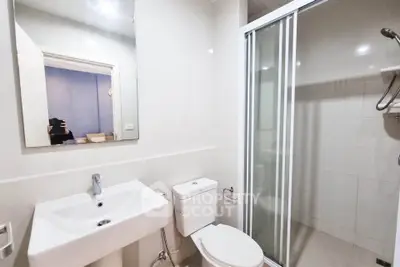 Modern bathroom with sleek fixtures and glass shower enclosure