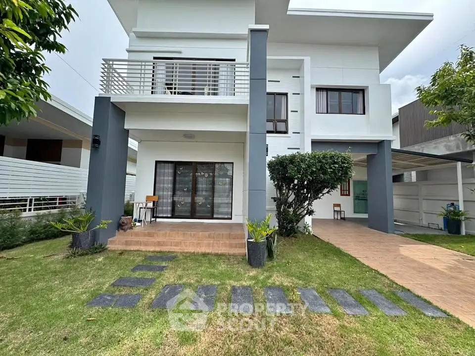 Modern two-story house with spacious lawn and stylish exterior design.