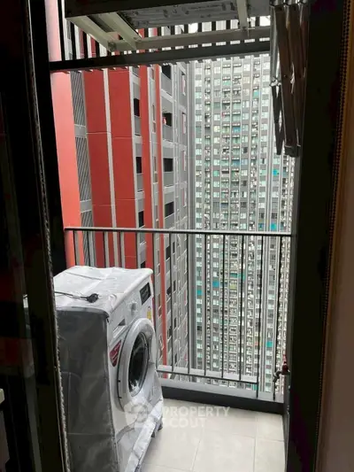 Urban balcony with washing machine and city view, perfect for modern living.