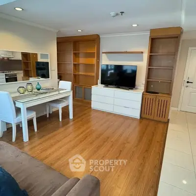 Spacious living room with modern decor and wooden flooring