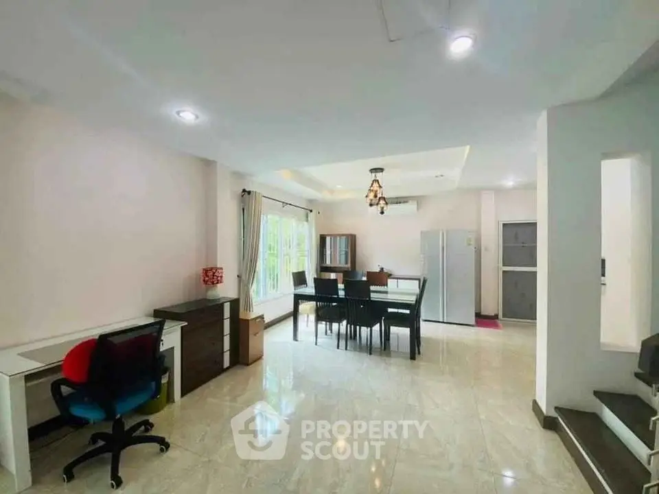 Spacious open-plan living and dining area with modern furnishings and natural light