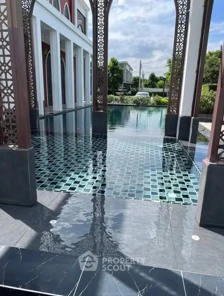 Luxurious poolside view with elegant architectural design and serene surroundings.