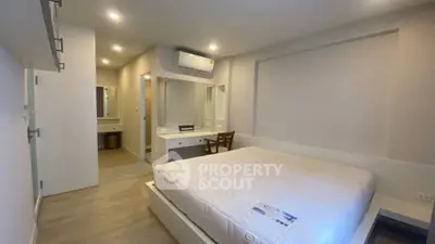 Spacious modern bedroom with minimalist design and built-in vanity