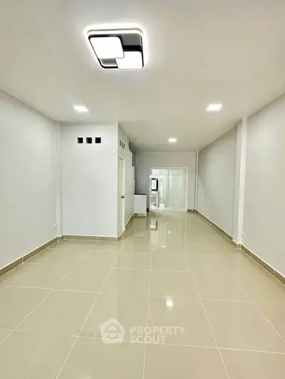 Spacious modern interior with sleek tile flooring and minimalist lighting