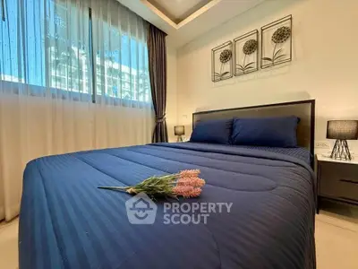 Elegant bedroom with modern decor and large window view