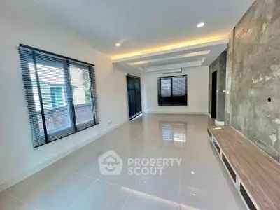 Spacious modern living room with sleek tile flooring and ambient lighting