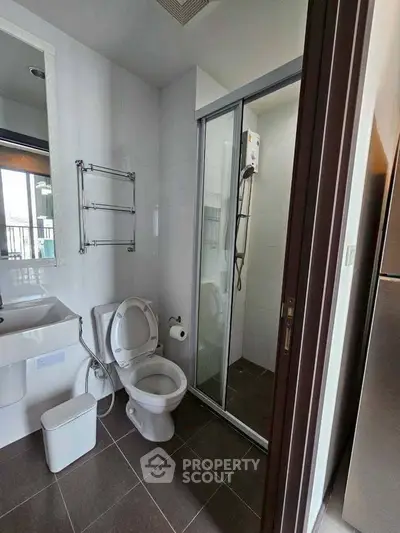 Modern bathroom with glass shower and sleek fixtures in a contemporary home.
