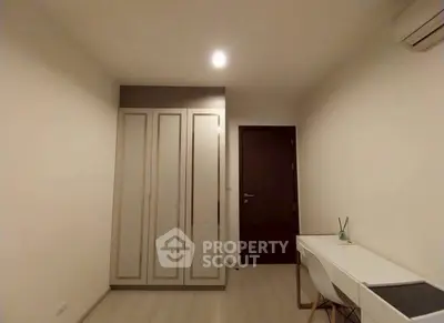 Minimalist bedroom with wardrobe and desk, perfect for a cozy living space.