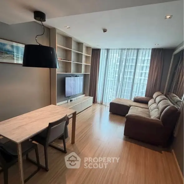 Modern living room with cozy sofa and large window in stylish apartment