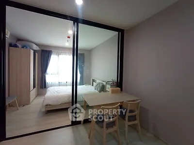 Modern bedroom with glass partition and cozy dining area