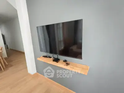 Modern living room with wall-mounted TV and minimalist decor