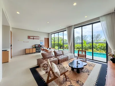 Spacious living room with pool view and modern decor