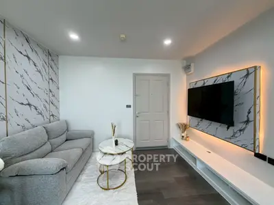 Modern living room with stylish marble accents and sleek TV setup