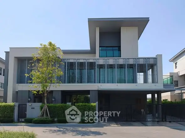 Modern luxury house with sleek design and spacious balcony in a serene neighborhood.