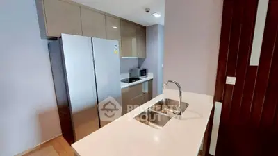 Modern kitchen with sleek cabinetry and double sink