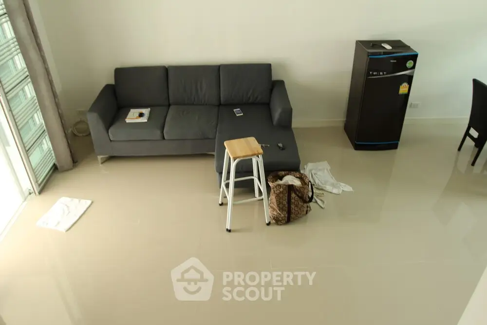 Modern living room with sleek sofa and minimalist decor, perfect for contemporary urban living.