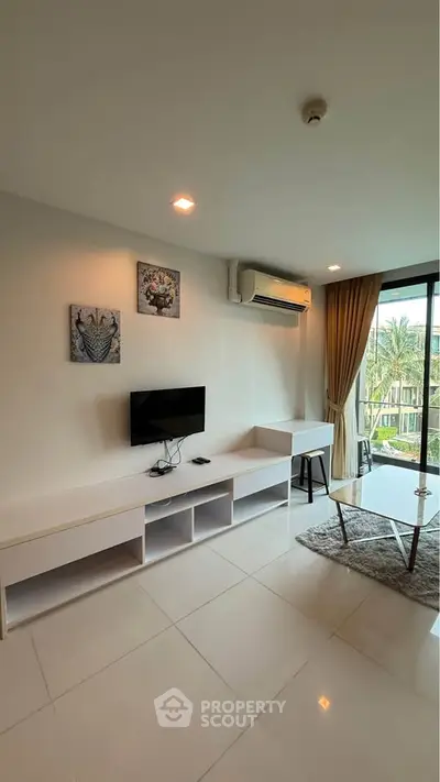 Modern living room with sleek furniture and large window offering natural light and garden view.