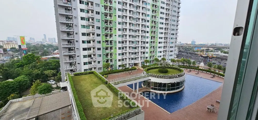 Stunning high-rise building with pool and garden view in urban setting.