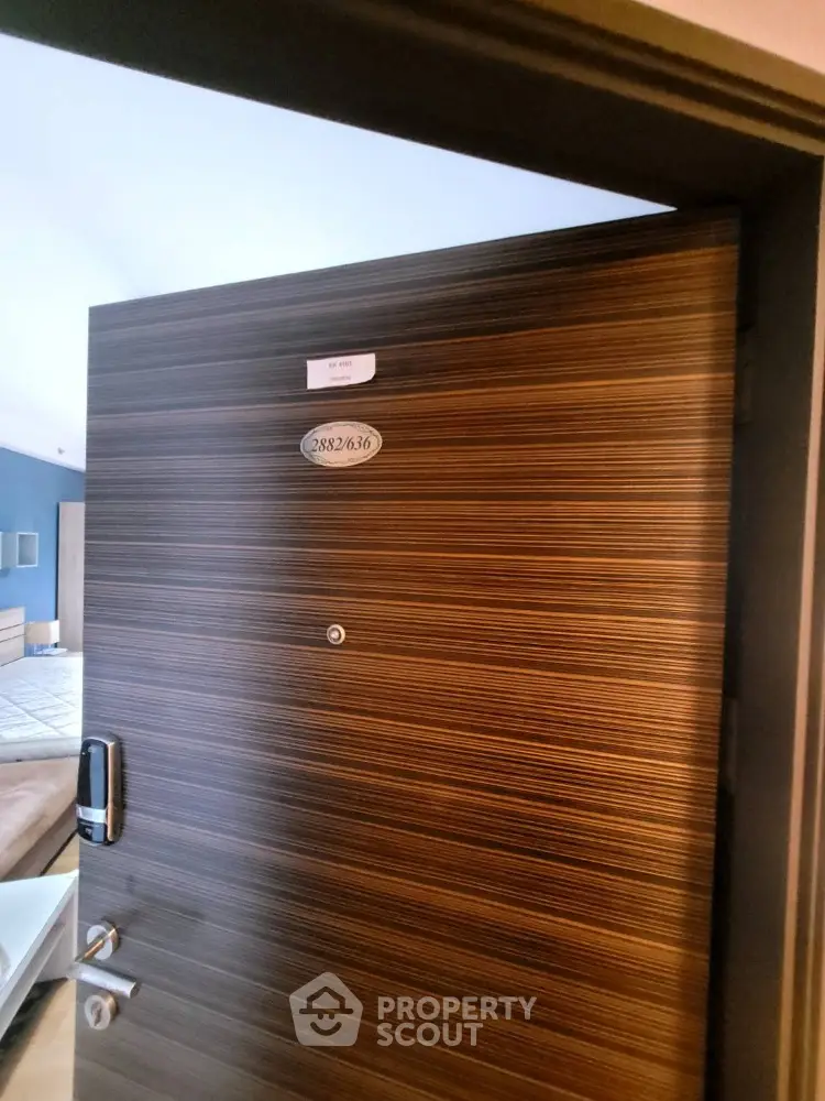Modern apartment entrance with electronic lock and stylish wooden door