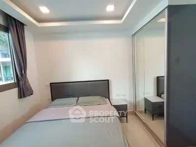 Modern bedroom with sleek design and mirrored wardrobe