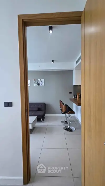 Modern open layout living room with sleek bar stools and contemporary decor