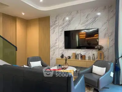 Luxurious modern living room with marble accent wall and sleek furniture