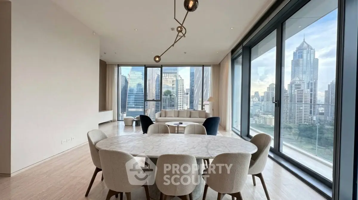 Luxurious dining area with stunning city skyline view in modern high-rise apartment.