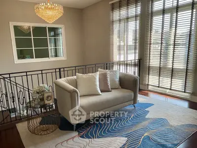 Elegant living room with modern sofa, stylish rug, and large windows with blinds.