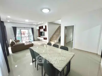 Spacious modern living and dining area with elegant marble table and stylish decor