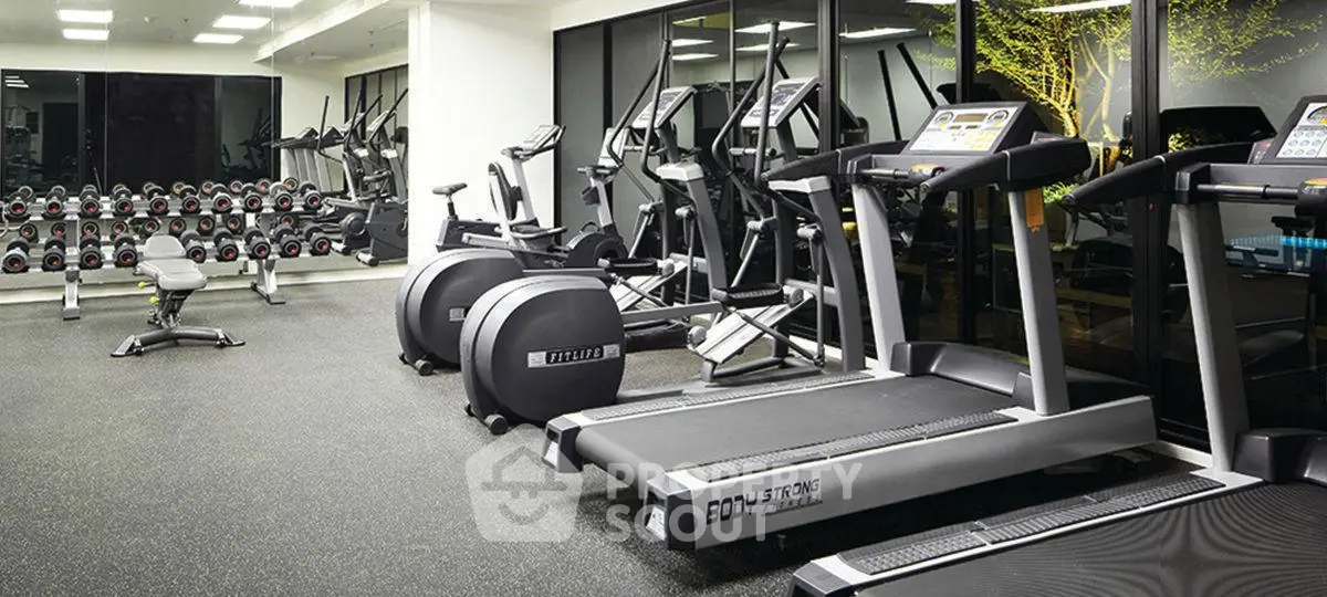 Modern gym with state-of-the-art equipment in a luxury residential building.