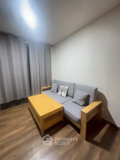 Cozy living room with modern gray sofa and wooden coffee table