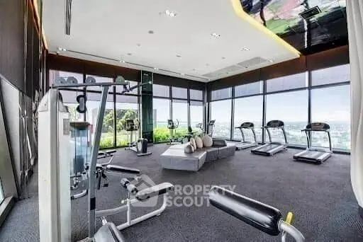 Luxurious high-rise gym with panoramic city views and modern fitness equipment.