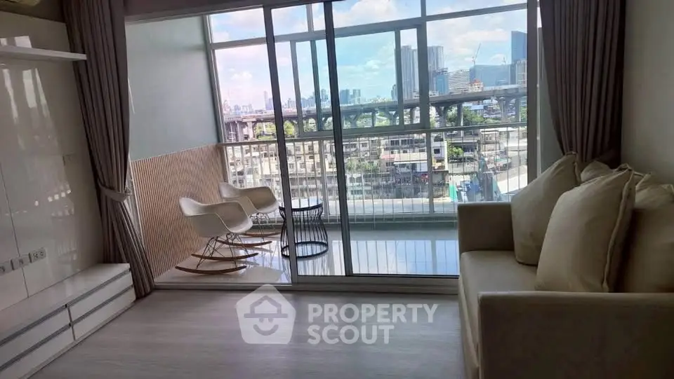 Modern living room with large windows and city view, featuring cozy seating and stylish decor.