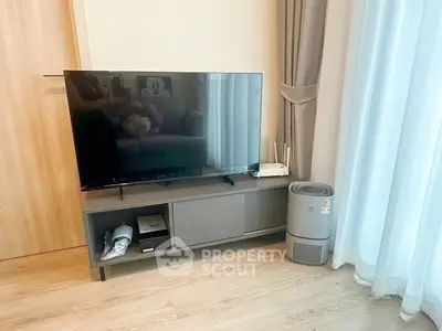 Modern living room with sleek TV stand and air purifier, featuring elegant curtains and wooden flooring.