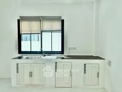 Modern kitchen with sleek countertops and ample cabinet space, perfect for culinary enthusiasts.