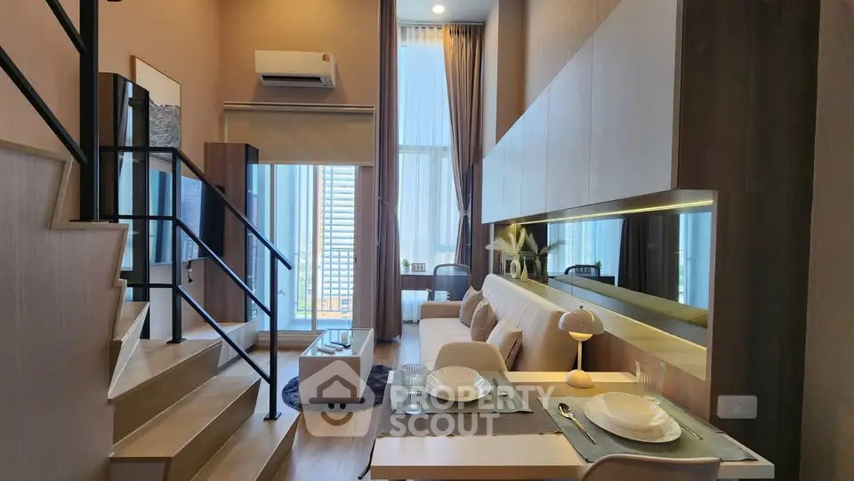 Modern duplex apartment with stylish living area and dining space, featuring high ceilings and large windows.