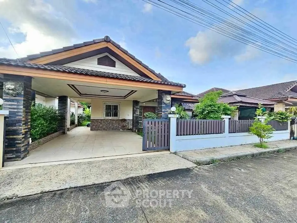 Charming single-story house with carport and lush garden in a serene neighborhood.