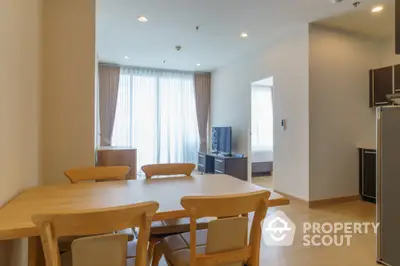 Modern dining area with wooden table and chairs in a bright apartment