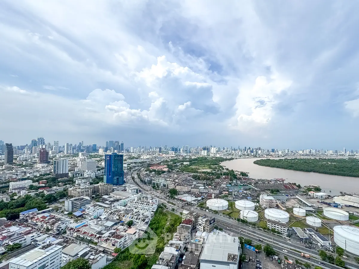 Stunning panoramic cityscape view with river and skyline, showcasing urban development and natural beauty.